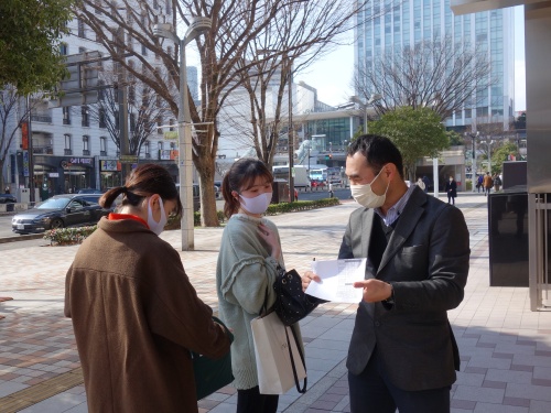 感染予防対策のため、屋外で学生を励ます山口先生