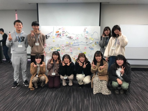 参加者で描いた「未来の宮城野区」をバックに学生たちは記念撮影